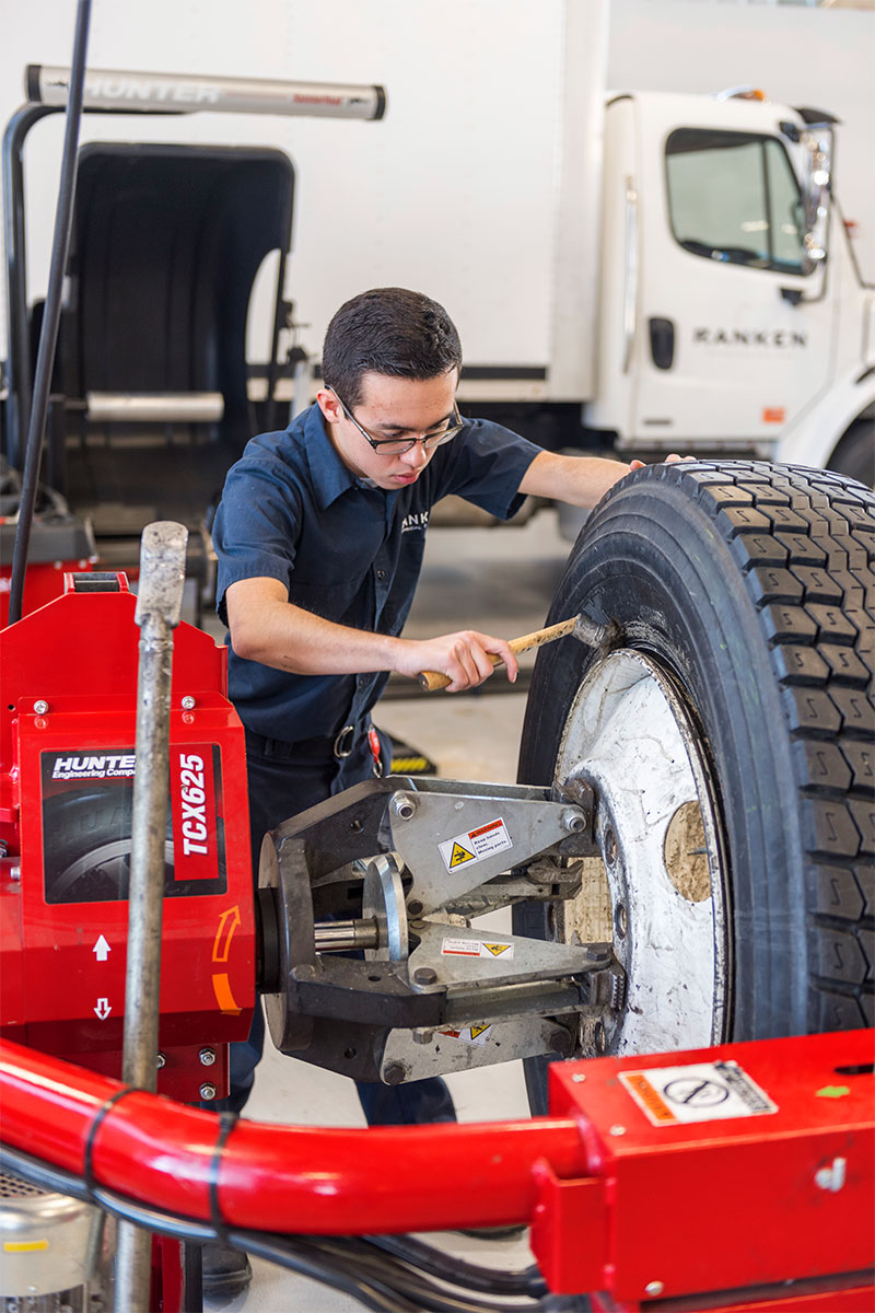 operator applying tire lube to heavy duty tire 